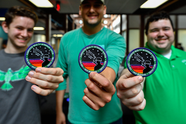 David Woodward, Juan Ruiz and Tim Stern display NASA patches