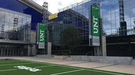 Football field with UNT vertical banners