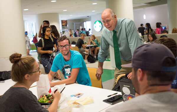 UNT President Neal Smatresk greets students