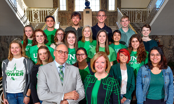 Debbie and Neal Smatresk with UNT's National Merit Scholars at the stairs in the Hurley Administration building