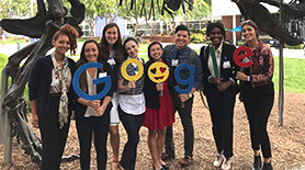 Students holding letters spelling Google