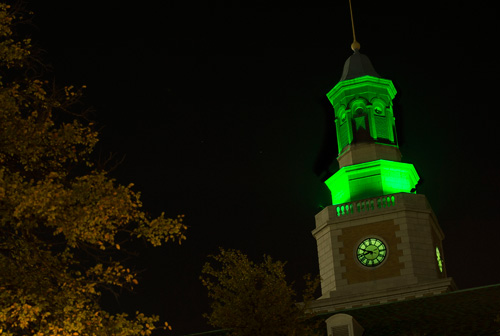 The UNT Hurley Administratino Building illuminated in green at night